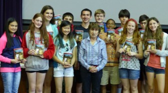 Johanna Reiss stands with members of the Lincoln Middle School's  8th grade class.