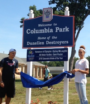 Dunellen resident Sydney McLaughlin and her brother Taylor reveal the new sign in front of Columbia Park, acknowledging her 2016 athletic accomplishments.