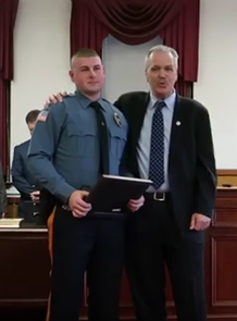 Patrick Barry, Dunellen's newest police officer, is congratulated by Mayor Bob Seader during the Council Reorganization Meeting on January 1, 2019.