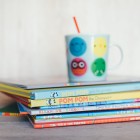 childrens booked stacked with sippy cup on top